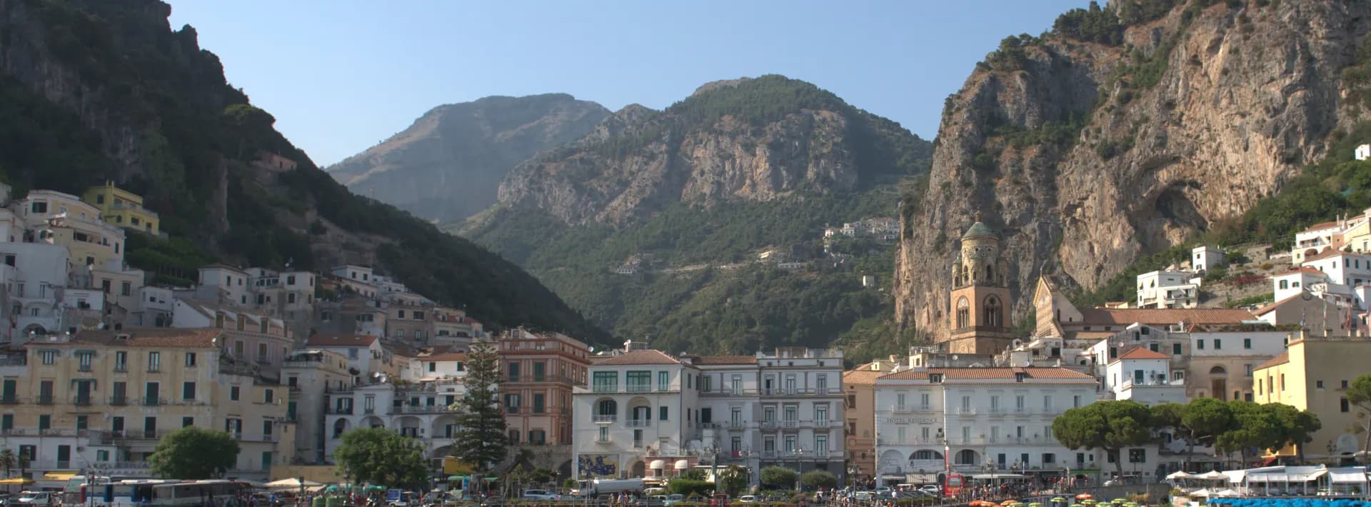 view of a city on the shoreline surrounded by cliffs in the background on the Amalfi Coast