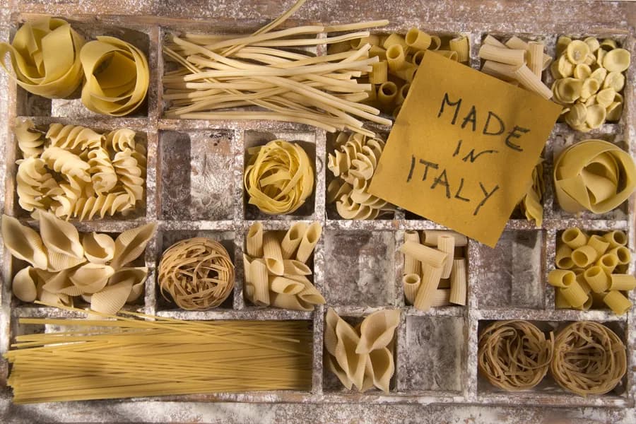 decorative arrangement of pasta varieties in a box with a sign that says Made in Italy