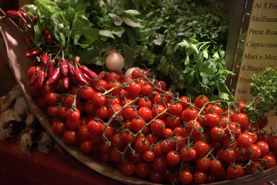 fresh tomatoes and herbs at a produce market in Italy