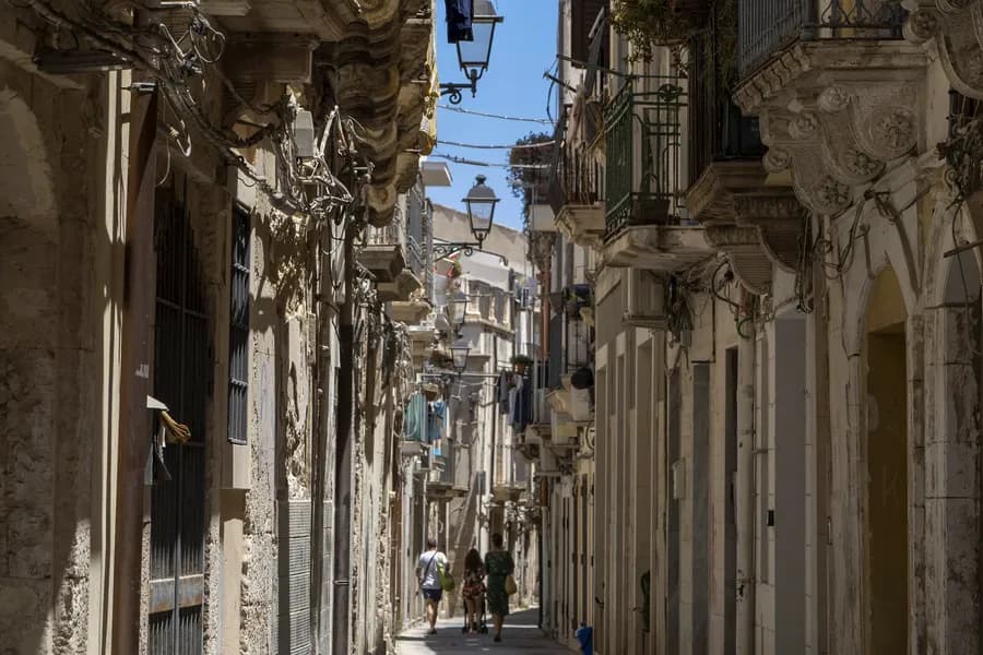 a narrow, winding street on the Island of Ortigia in Syracuse
