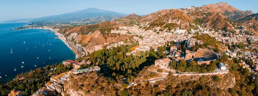 an aerial view of Isola Bella in Taormina, Italy
