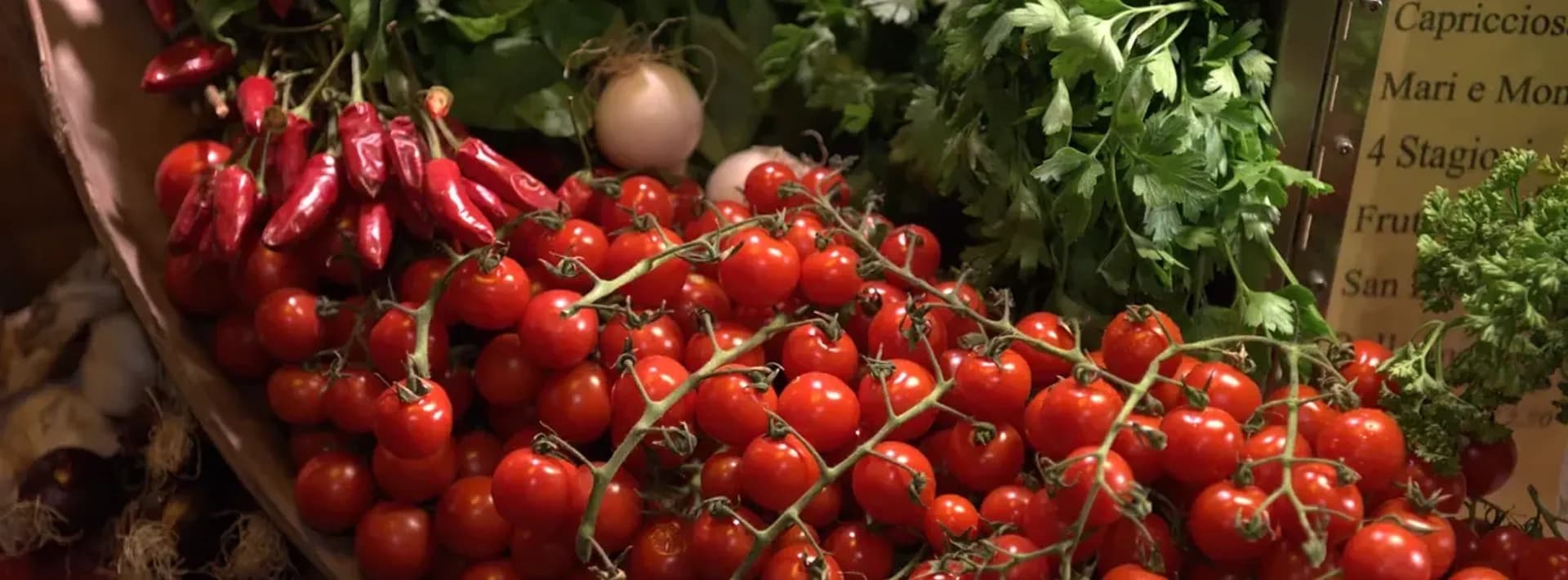 fresh tomatoes and herbs at a produce market in Italy