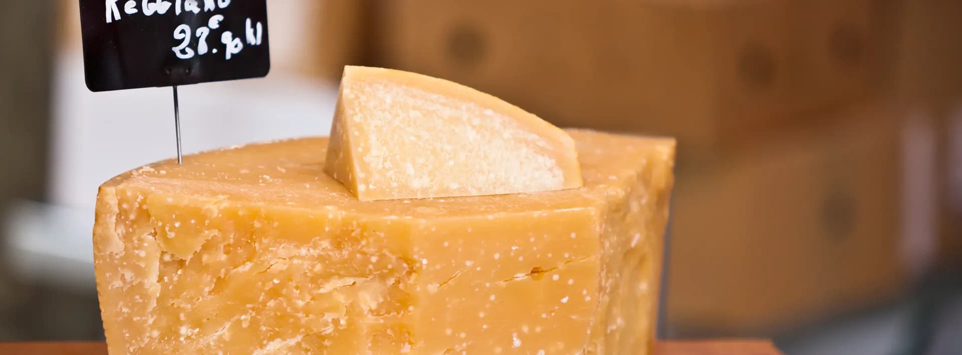 a small block of parmesano reggiano on display in a shop