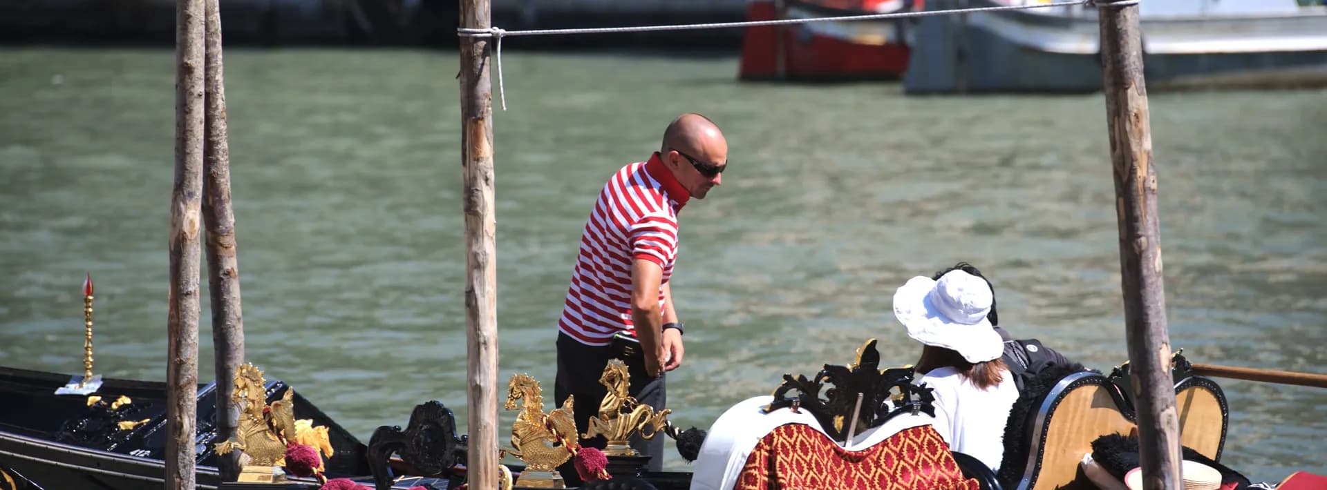Close up of gondola passengers talking to the captain in Venice, Italy.
