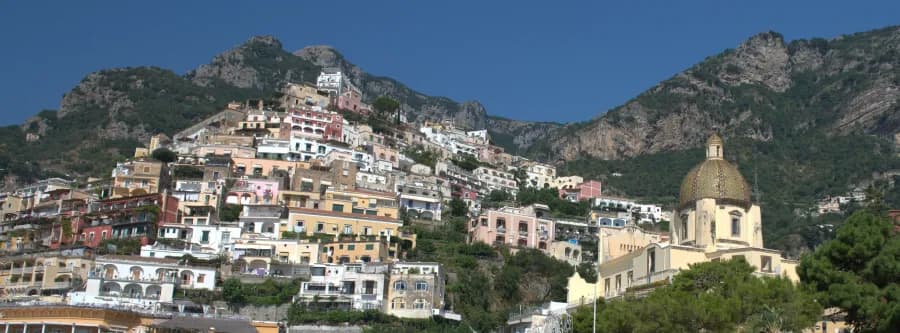 view of a city carved into the cliffside on the Amalfi Coast
