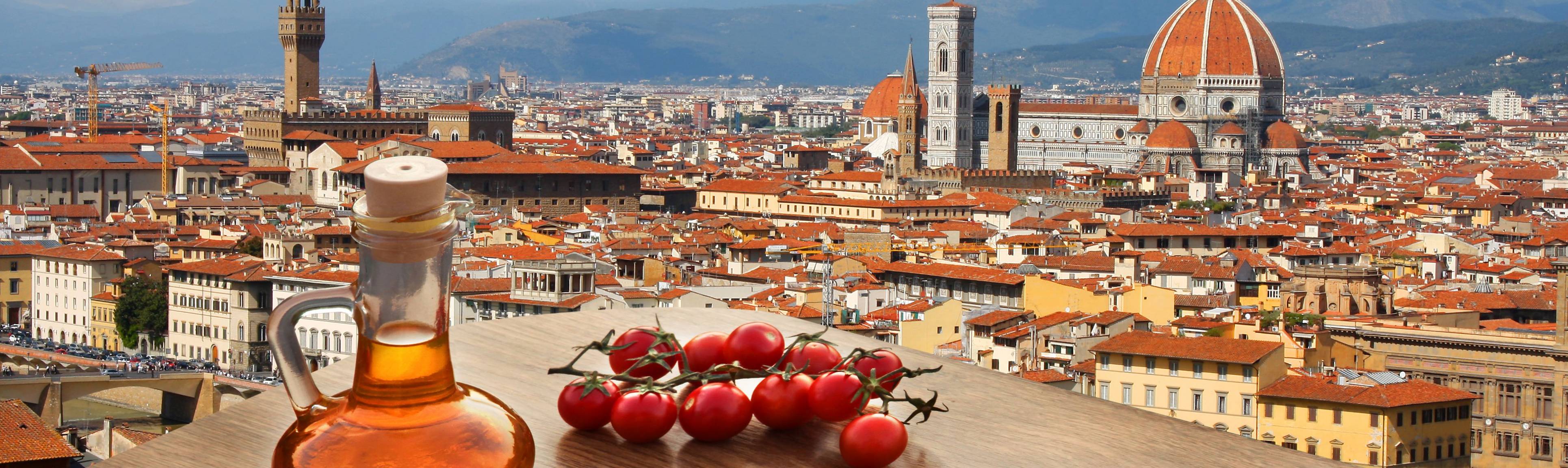 Tomatoes & olive oil on a table overlooking the rooftops of Florence