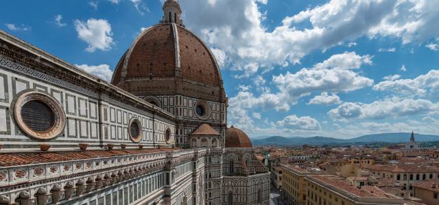 Colorful marble decorating Il Duomo Cathedral with a view of Florence