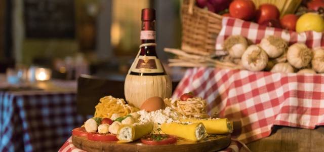 Detail of table with cheese, fruits and wine in Italy