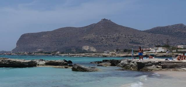 View of rocks with mountain backdrop at Favignana Beach, Sicly