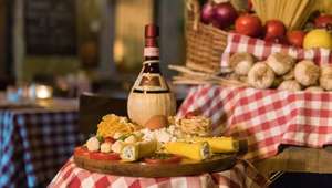Detail of table with cheese, fruits and wine in Italy