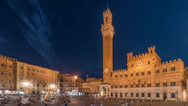Evening view of tower and buildings at Palazzo Pubblico in Siena, Italy