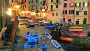 Colorful boats and buildings adorn the Port of Cinque Terre at night