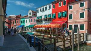 Colorful buildings alongside a canal on the island of Burano in Venice