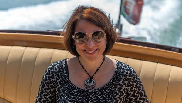 Carmen, Your Own Italy's founder & President riding on a boat in Venice