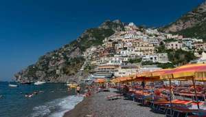 View of black sand beach with Positano rising in the background